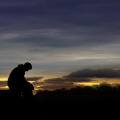Sad man sitting in sunset