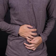 man holding stomach in pain